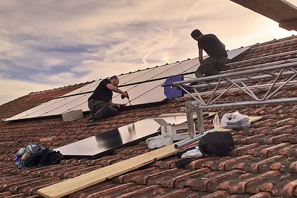 Les frères Desjardins de la société Elec'eaux en train de poser des panneaux solaires